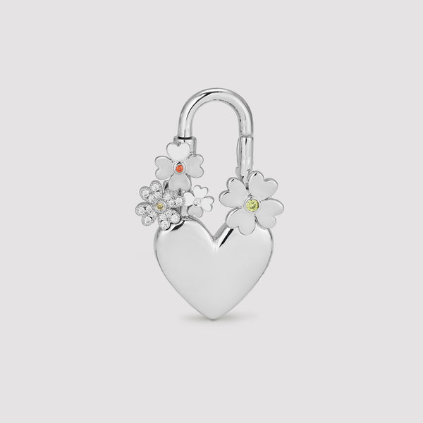 Silver heart-shaped padlock with floral designs on a light gray background
