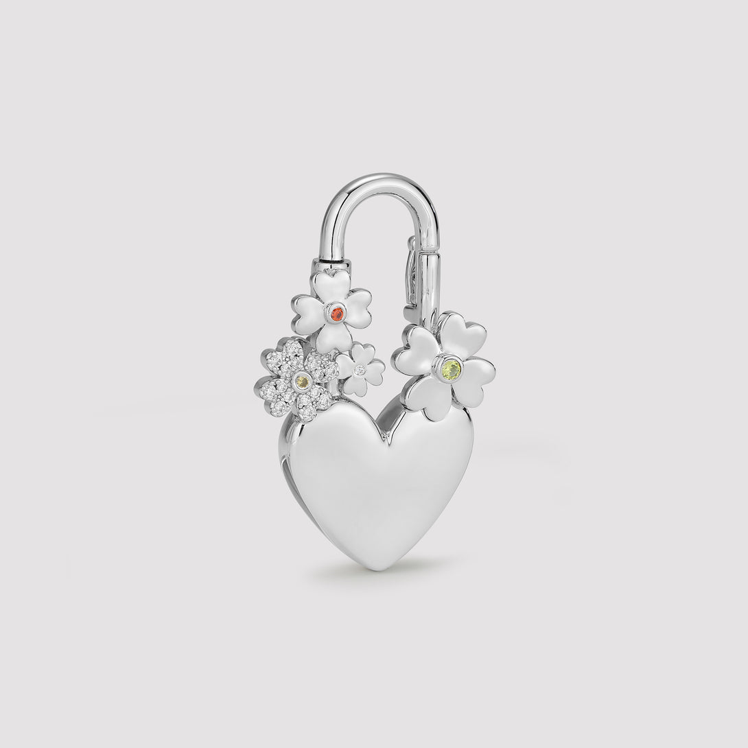 Silver heart-shaped padlock with floral designs on a light gray background