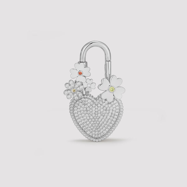 Silver heart-shaped padlock with floral designs on a light gray background