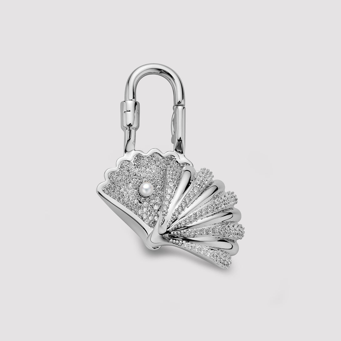 Silver interior of seashell bag charm on a light gray background, this bag charm is design for hermes bag