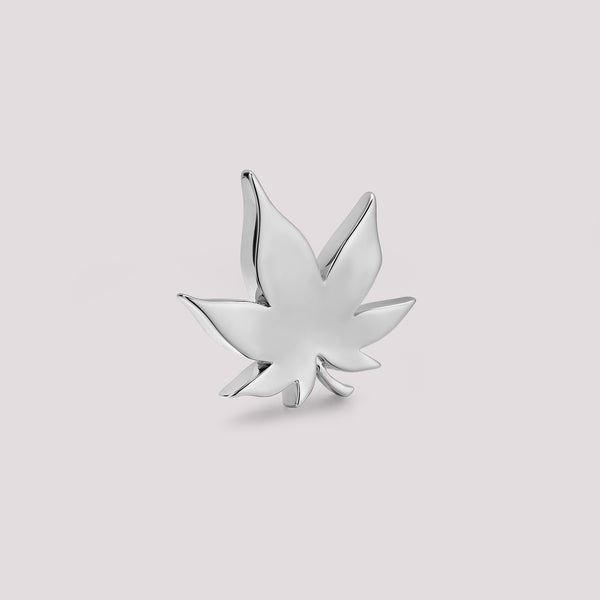 Silver cannabis leaf-shaped bag charm on a light gray background